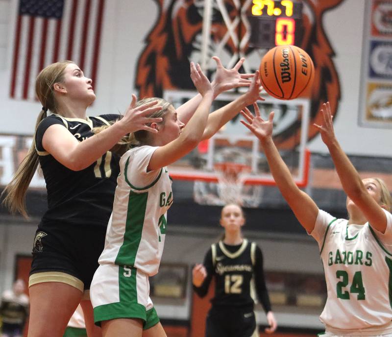 Crystal Lake South’s Makena Cleary, center, and Gracey LePage, right, battle Sycamore’s Macy Calendo for the ball in girls IHSA Class 3A Sectional basketball on Tuesday, Feb. 24, 2026, at Crystal Lake Central High School in Crystal Lake.