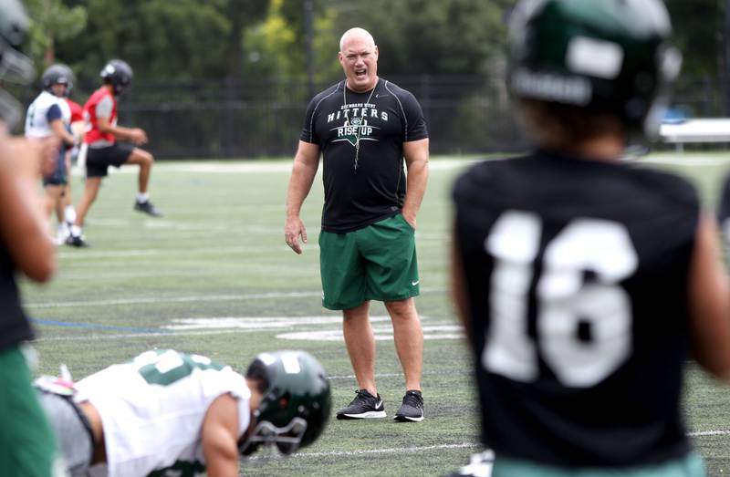 Glenbard West Head Coach Chad Hetlet leads his team during the first official day of practice in Glen Ellyn on Monday, Aug. 8, 2022.