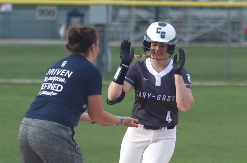Cary-Grove’s Maddie Crick rounds the bases on a home run against Burlington Central in varsity softball at Cary Monday.