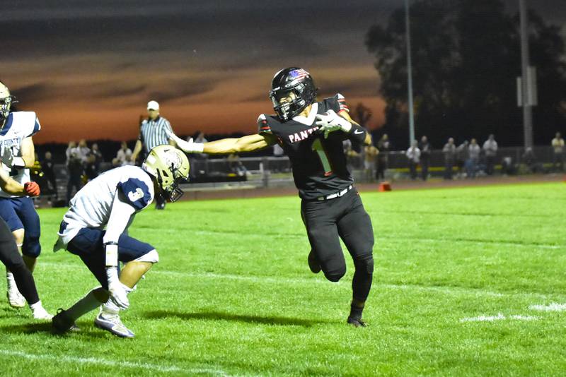 Erie-Prophetstown's Demetree Larsen stiff arms his way up the field to dive into the end zone to give the Panthers their first touchdown of the night on Friday, Sept. 27, 2024 against the visiting Mercer County Eagles.