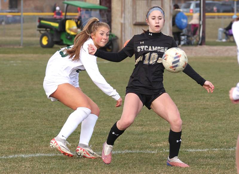 Sycamore's Faith Schroeder tries to hold off Crystal Lake South's Gracey LePage during their game Thursday, March 21, 2024, at Sycamore High School.