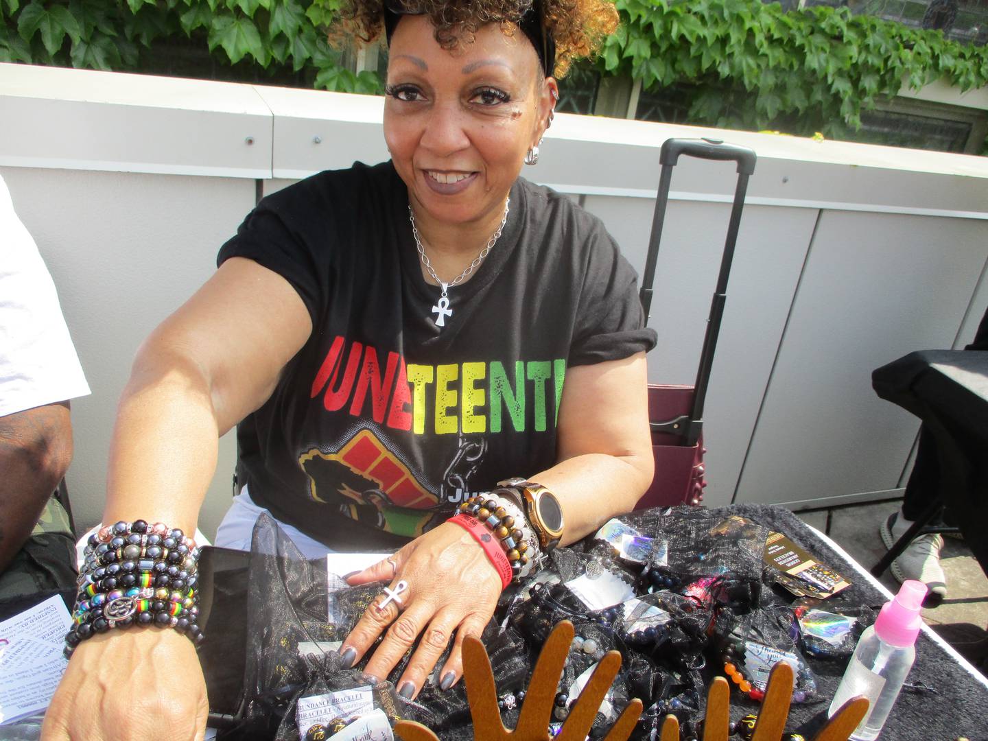 Johnetta Stokes shows the many bracelets made by her Goddis Awareness Bracelets, including a freedom bracelet, during the Juneteenth event at the Joliet Area Historical Museum on Sunday, June 18.
