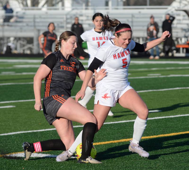 Oregon's Ava Carenno (5) and Freeport's Natalie Namio (12) fight for the ball during a Monday, March 31, 2025 game at Freeport High School.