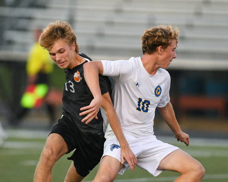 Wheaton Warrenville South's Noah Giannasi (13) and Wheaton North's Rocco Johnson (10) battle for the ball during the game on Thursday Sept. 11, 2025, held at Wheaton Warrenville South.