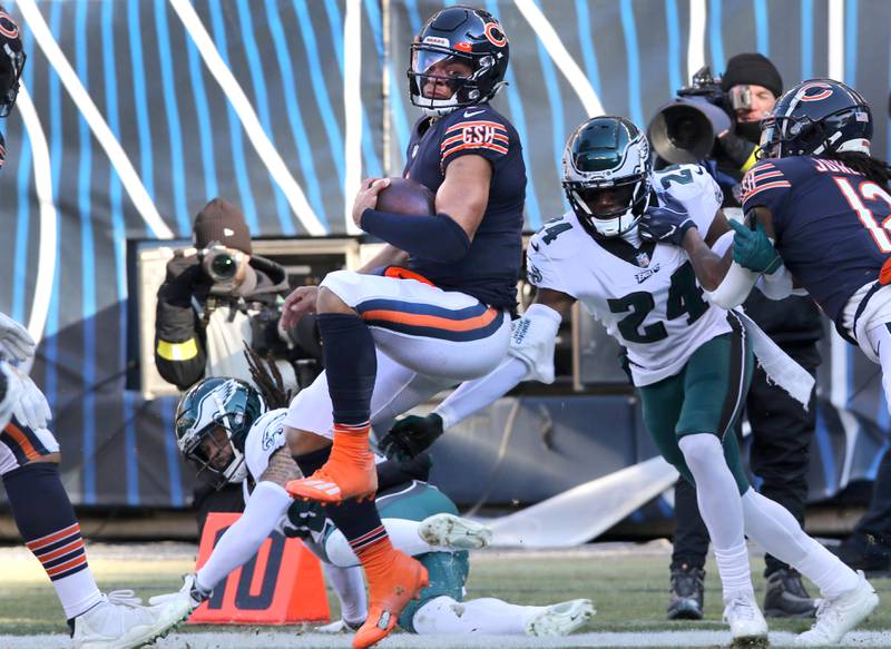Chicago Bears quarterback Justin Fields spins away from Philadelphia Eagles cornerback James Bradberry on a long run that set up a touchdown during their game Sunday, Dec. 18, 2022, at Soldier Field in Chicago.
