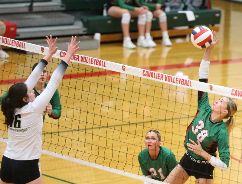 L-P's Aubrey Duttlinger spikes the ball past Sycamore's Norah Chami on Tuesday, Oct. 15, 2024 in AJ Sellett Gymnasium at L-P High School.