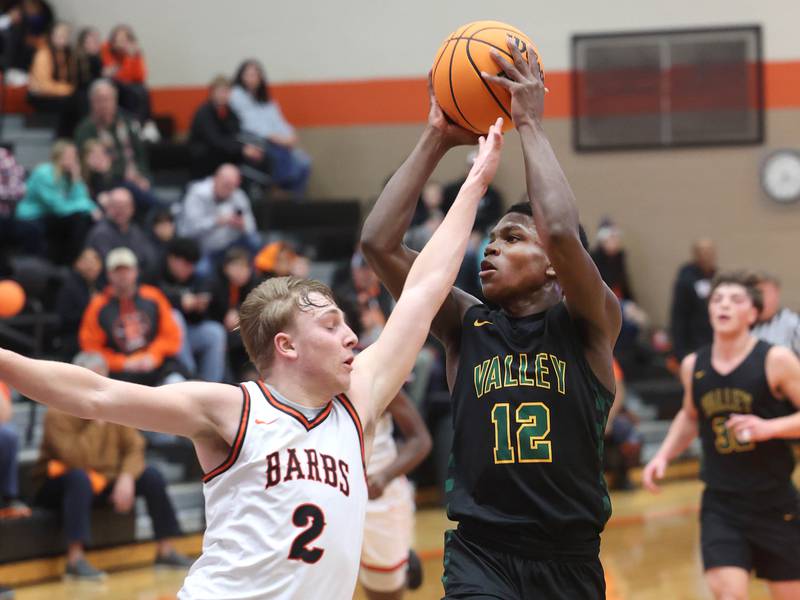 Waubonsie Valley's Tyreek Coleman shoots over DeKalb's Sean Reynolds during their game Friday, Feb. 21, 2025, at DeKalb High School.
