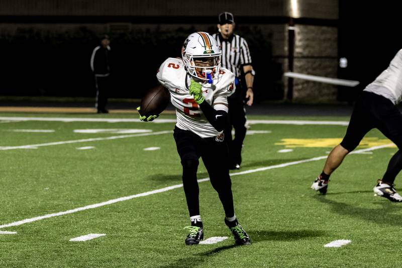 Plainfield East's Camren Smith runs the ball during a varsity football game against Joliet West at Joliet West on Oct. 10, 2025.