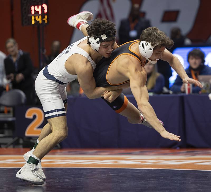 IC Catholic’s Frank Nitti throw’s Crystal Lake Central’s Nicholas Marchese the 2A 144 pound class Saturday, Feb. 21, 2026, at the IHSA wrestling finals in Champaign.