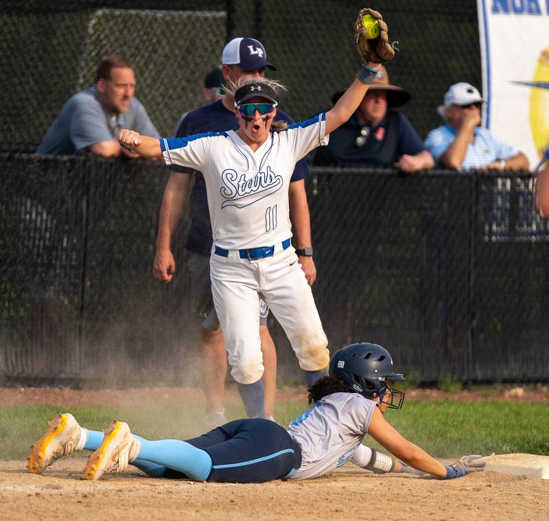 St. Charles North's Auburn Roberson (11) reacts after tagging out Lake Park's Juliana Dowling (4) on a pickoff play during a softball game at St. Charles North High School on Wednesday, May 11, 2022.