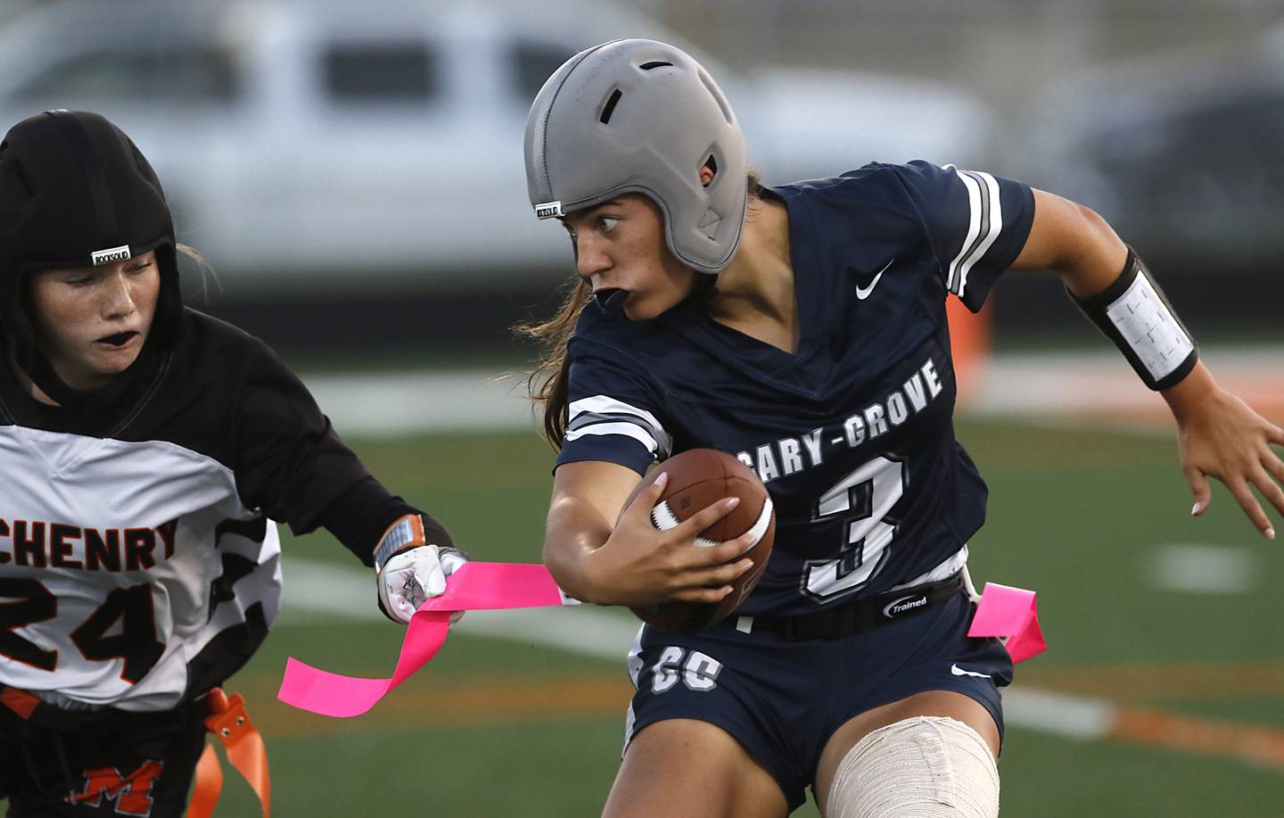 McHenry's Danica McCarthy grabs the flag of Cary-Grove's Kennedy Manning during the IHSA McHenry Regional girls flag football championship game on Wednesday, Oct. 8, 2025, at McCracken Field in McHenry.