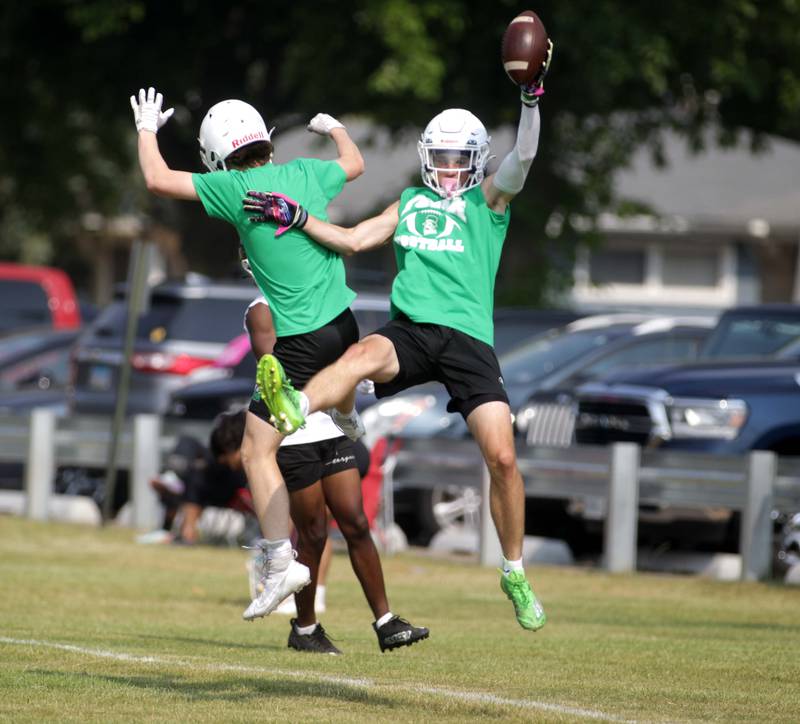York’s Luke Mailander (right) celebrates a touchdown during a 7-on-7 football tournament at West Aurora High School on Friday, June 23, 2023.
