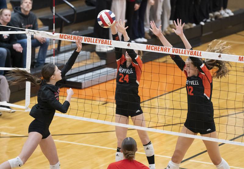 Huntley's Izzy Whitehouse returns the ball to Libertyville's Makenzie Tyrrell, 24, and Avery Maddux, 12, during the Class 4A Sectional girls volleyball final on Thursday, November 7, 2024 at McHenry High School. Ryan Rayburn for Shaw Local