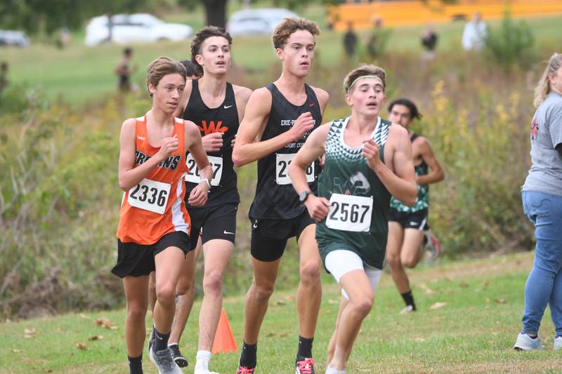 West Carroll's Roscoe Davies (right) and Erie-Propphetstown's Nathan Punke (center) run at the Amboy Columbus Day Cross Country Invitational held at Shady Oaks Country Club near Amboy on Monday, Oct. 13, 2025.
