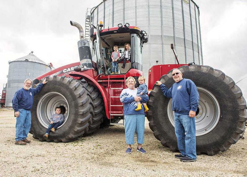 Generations of the Gilmores have been farming the land for nearly 200 years. Today,  Steve Gilmore (far left) and his brother Scott (far right) oversee the family operation. Seen here with the brothers are, from left, Edward Kofoid, 5, Maverick Schoenholz, 4, Ella Schoenholz, 6, Marianne Gilmore, and Evelyn Kofoid, 1.