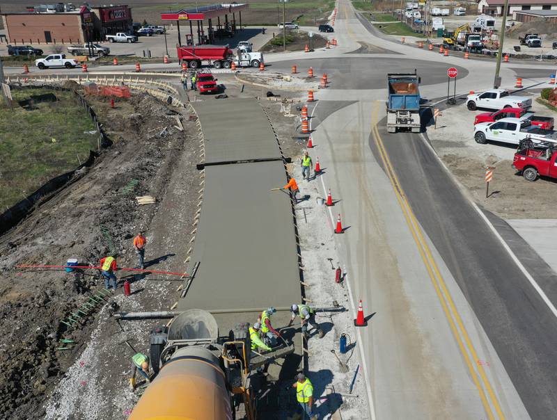 Workers pour a large section on the south side of the roundabout at the intersection of Route 71 and Illinois 178 on Tuesday, April 11, 2023 in Utica.