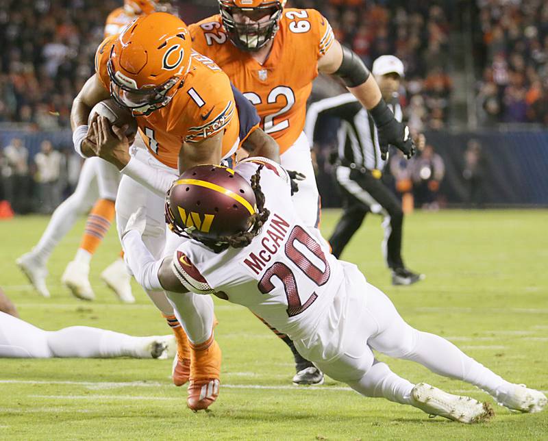 Chicago Bears quarterback Justin Fields is stopped short of the goal line by Washington Commanders Bobby McCain (20) on Thursday, Oct. 13, 2022 at Soldier Field.