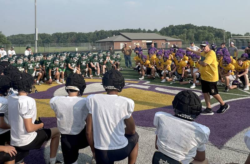 Mendota head football coach Jim Eustice (right) talks to St. Bede and Sandwich football players before a joint practice on Thursday, July 31, 2025 at Mendota High School.