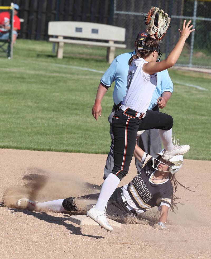 Sycamore's Bella Jacobs slides in with a stolen base under Freeport's Kailen Pro during their Class 3A regional championship game Friday, May 26, 2023, at Sycamore High School.