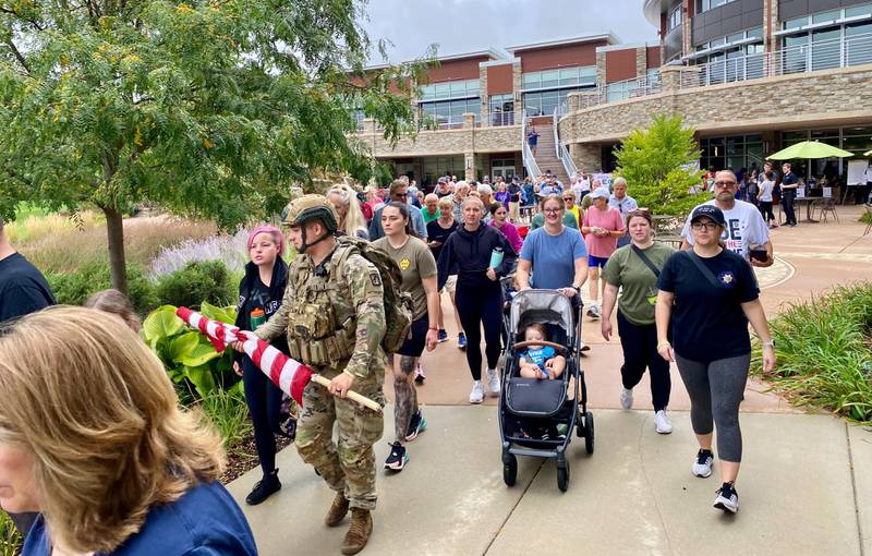 (Second from left) U.S. Army veteran and reserve member Stephen Cox, 24, of DeKalb, walks with his wife, Kimberly Cox, also 24 of DeKalb, in the inaugural Be the One Walk to raise awareness about veteran suicide rates in DeKalb on Sunday, Sept. 22, 2024.