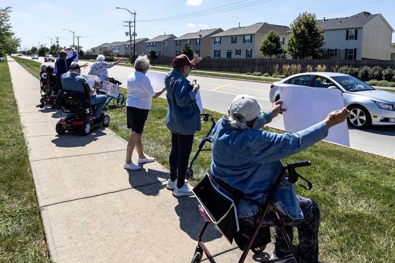 ‘Workers Over Billionaires’ Labor Day Protest participants wave to passing cars on the 1100 block of N. River Rd. in Shorewood, IL, on Sept. 1, 2025.