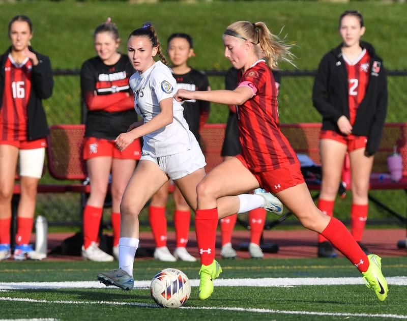 Hinsdale Central’s Peyton Rohn (11) Races with the ball as Lyons Township’s Audrey McCarty defends during a game on April 29, 2025 at Hinsdale Central High School in Hinsdale.