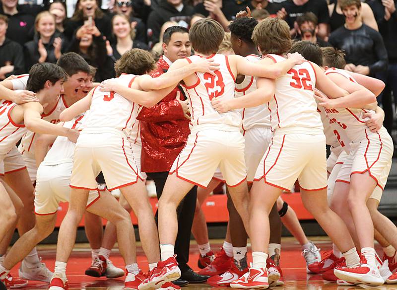 Members of the Ottawa boys basketball team huddle before the game in Kingman Gymnasium on Friday, Feb. 10, 2023 at Ottawa High School.