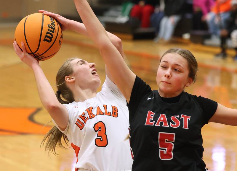 DeKalb's Olivia Schermerhorn gets up a shot over Rockford East's Aubrey Phillip during their game Wednesday, Jan. 22, 2025, at DeKalb High School.