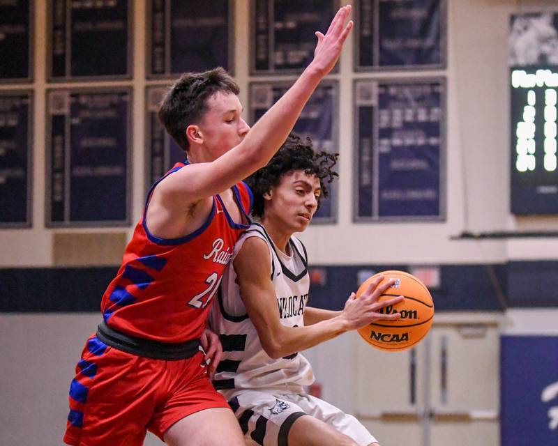 West Chicago's Jaxon Williams, right, tries to get around Glenbard South's Will Sieck (20) during the game on Friday Jan. 3, 2025, held at West Chicago High School.