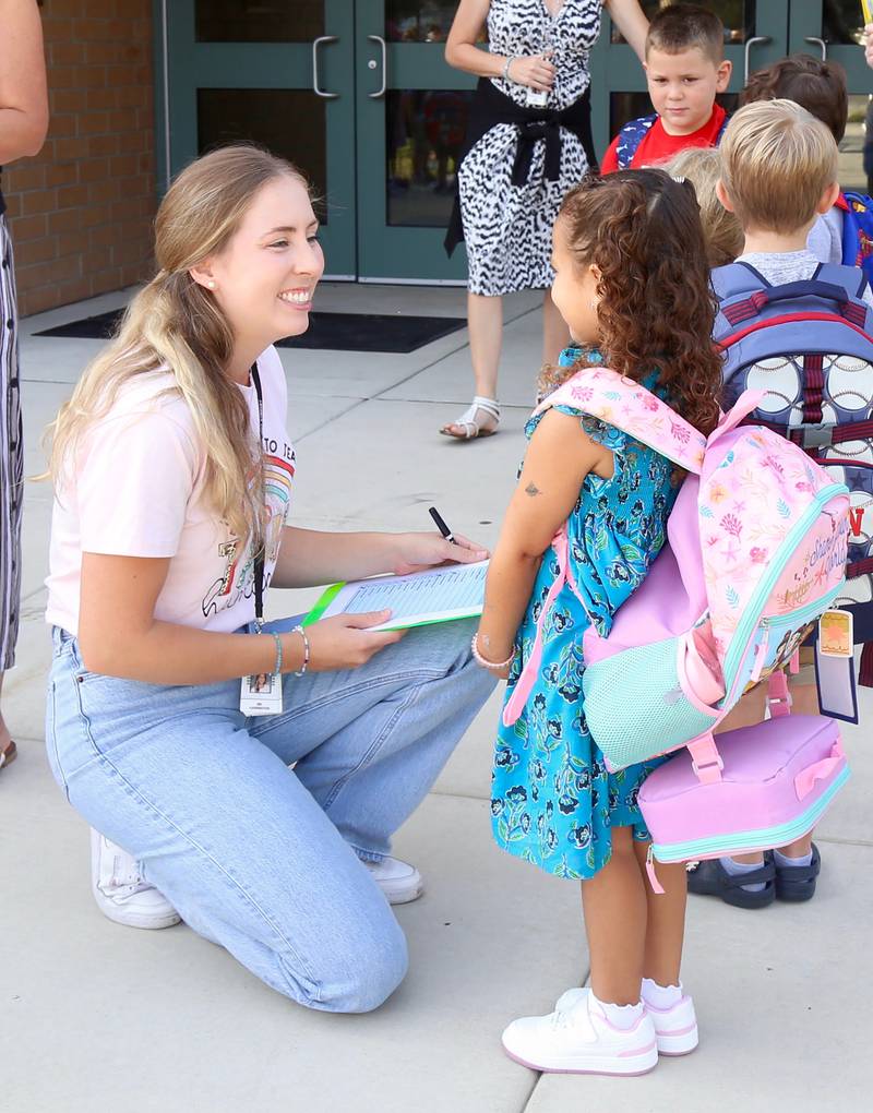 Kindergarten teacher Taylor Carrington greets a student at Kaneland John Stewart Elementary in Elburn on Wednesday, Aug. 14, 2024.