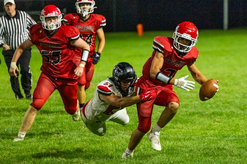 Dylan Glynn (7) of Hall runs ball as Derek Naftzger (51) of Erie-Prophetstown attempts to drag down on Friday, Sept 5, 2025 at Richard Nesti Stadium in Spring Valley.