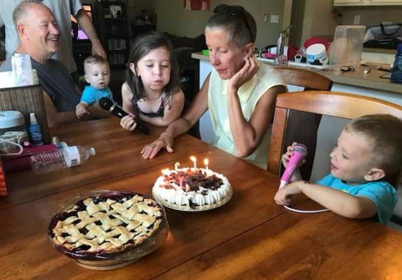 Joni Hilger prepares to blow out her birthday candles while her husband Tom Hilger and grandchildren Kayden, Ryleigh and Blake look on.