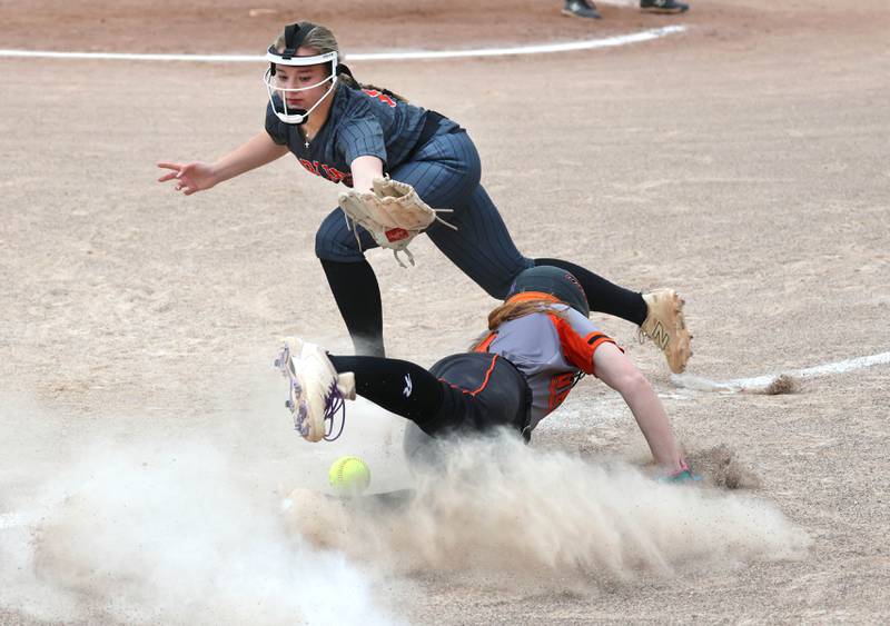 DeKalb's Cassidy Cavazos slides safely into third as Harlem's Olivia Christiansen can’t catch the throw Tuesday, May 19, 2026, during their Class 4A regional game at DeKalb High School.
