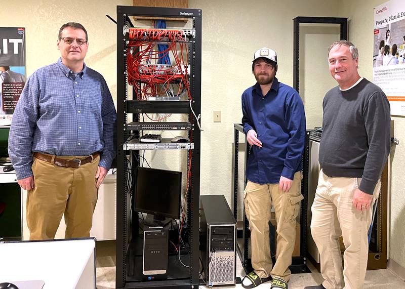 Travis Null (center) built and reconfigured a business-critical PC for the Morrison Institute of Technology, designed middle school STEM activities and assisted and supported dual enrollment instruction for area high school students. He is shown with Morrison Tech instructors Robert Anderson (left) and Scott Connelly.