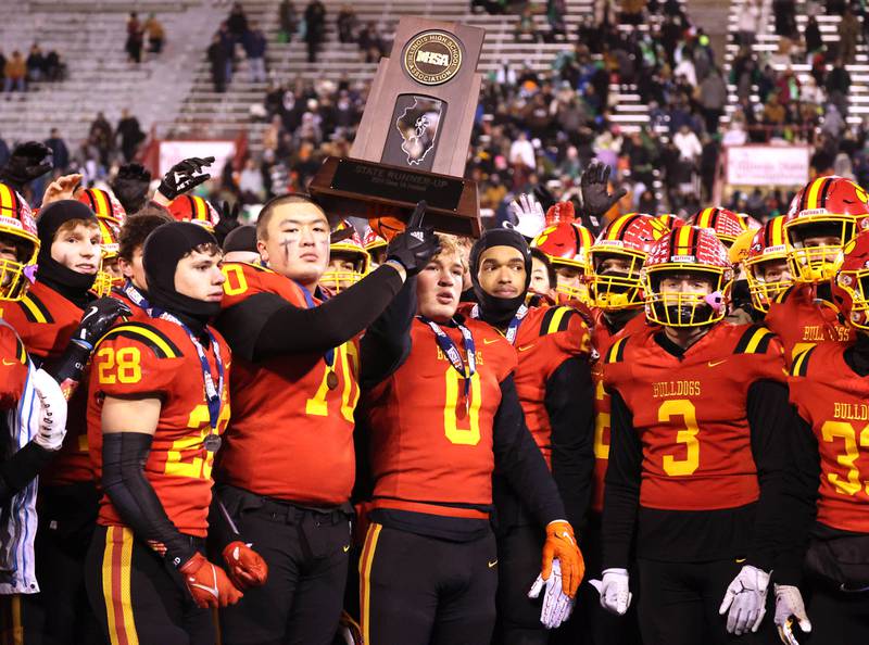 Batavia players hoist the second place trophy after their Class 8A state championship game loss to Mt. Carmel Saturday, Nov. 30, 2024, in Hancock Stadium at Illinois State University in Normal.