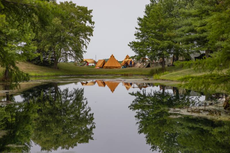 Tents from the Polish military encampment reflect off of the surface of a pond during the Ottawa Military Show on July 13, 2025 in rural Ottawa.