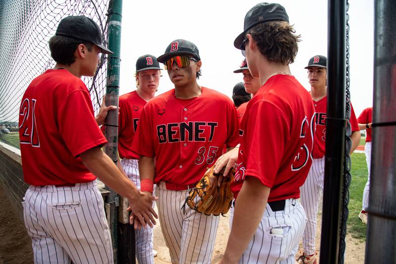 Benet Academy’s Ethan Mendez high-fives his teammates between innings during the School Class 3A Kaneland Sectional final against St. Francis High School at Kaneland High School in Maple Park on Saturday, June 7, 2025.