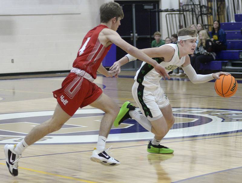 Seneca’s Paxton Giertz gets by Hall’s Luke Bryant on a drive in the 1st period Monday at the Serena Huskers Hardwood Tip-Off Tournament.
