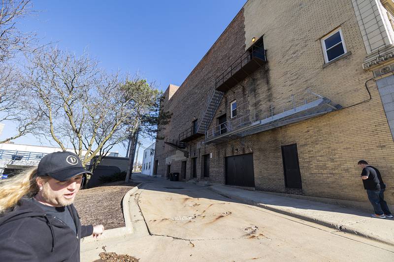 The Dixon technical director Scott Shipp (left) gestures toward areas on the building that need to be tuckpointed Wednesday, March 6, 2024. The theater will be closed part of this year to tackle roof and brick repairs.