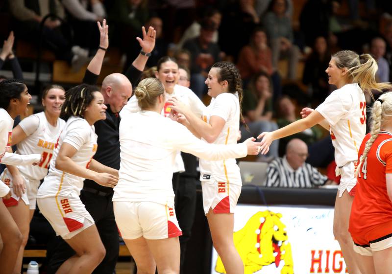 Batavia’s Brooke Carlson (center) celebrates breaking the school’s all-time points scored during a game against St. Charles East at Batavia on Thursday, Feb. 1, 2024.