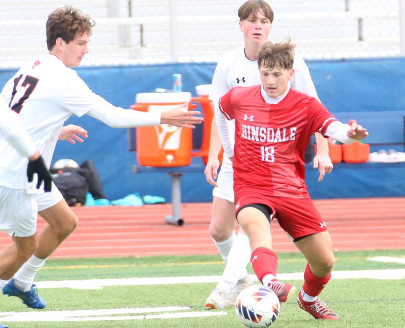 Hinsdale Central's Austen Szurgot dribbles around Edwardsville's Jack Marty and teammate Caden Berhaix during the Class 3A State third place game on Saturday, Nov. 9, 2024 at Hoffman Estates High School.