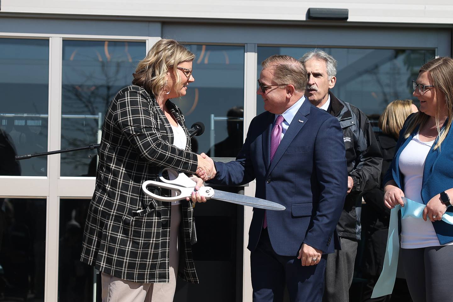 Brianne Hetman, Senior Services Center of Will County CEO, shakes hands with Romeoville Mayor John Noak at the Ovation Center ribbon cutting ceremony on Wednesday, April 24, 2024 in Romeoville.
