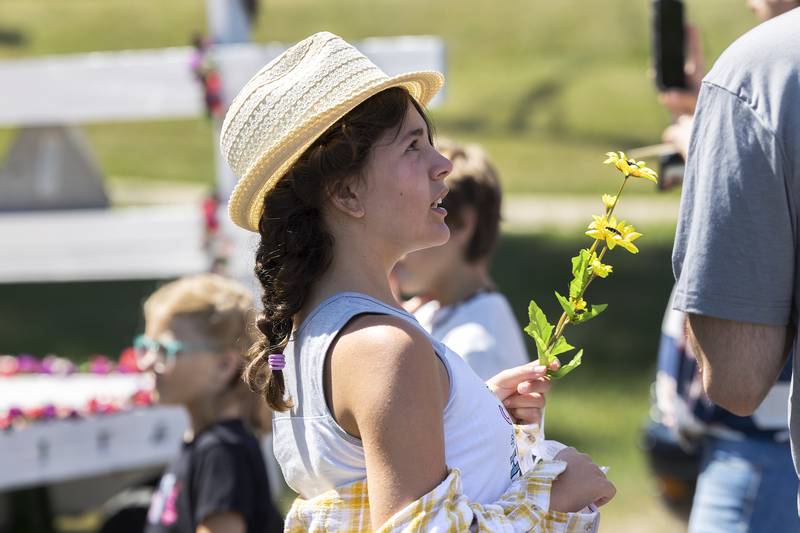 Serina Ganze wears one of her great-grandmothers hats while graveside Friday, July 7, 2023.