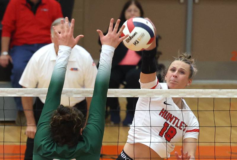 Huntley's Sienna Robertson tries to spike the ball past Fremd’s Victoria Belmonte Monday, Nov. 11, 2024, during their Class 4A supersectional match at DeKalb High School.