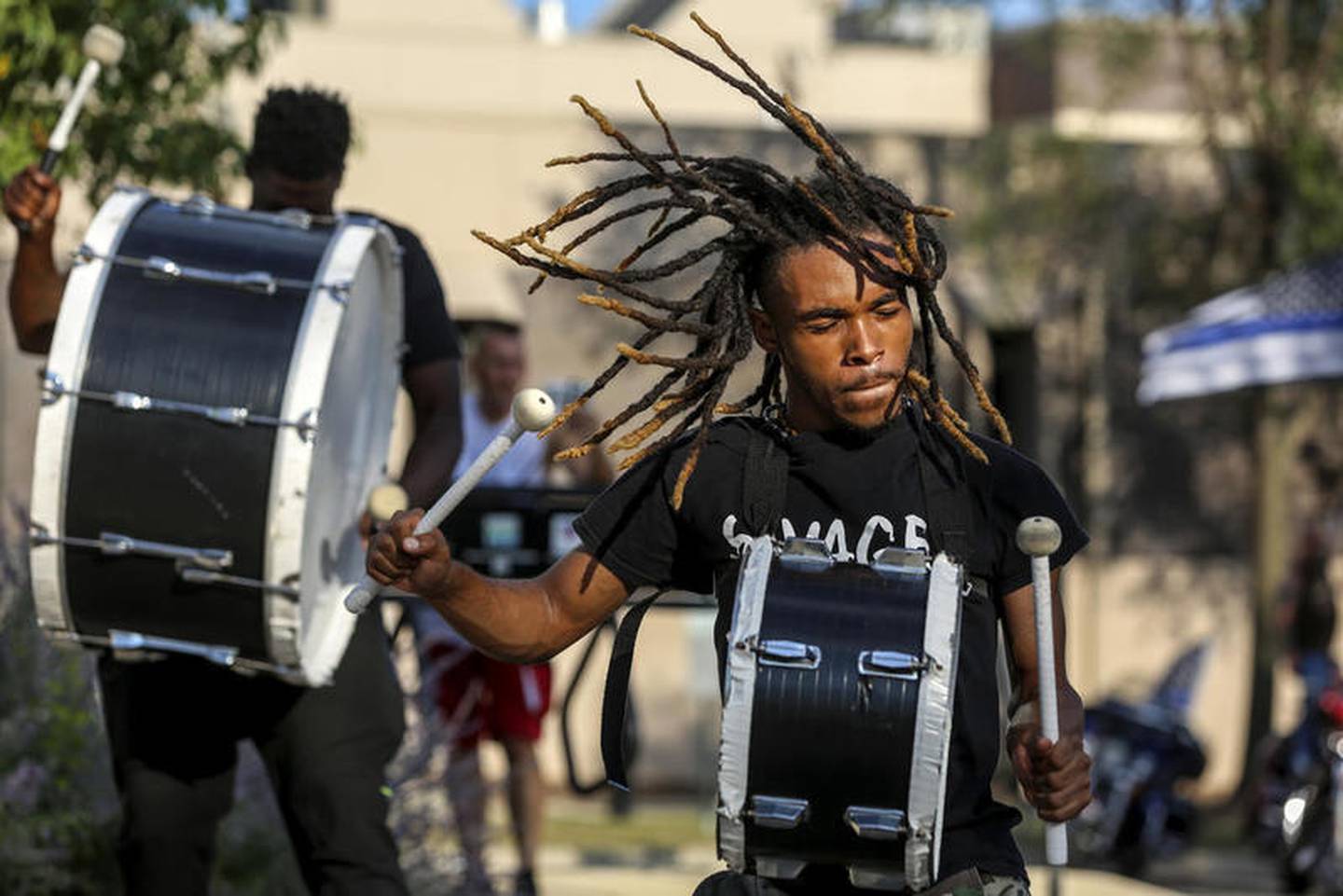 Demonstrators can be seen playing drums outside Joliet City Hall, the Will County Courthouse and the Joliet Police Department on Saturday, Aug. 22, 2020, in response to the January 28 overdose death of Eric Lurry who died in police custody.