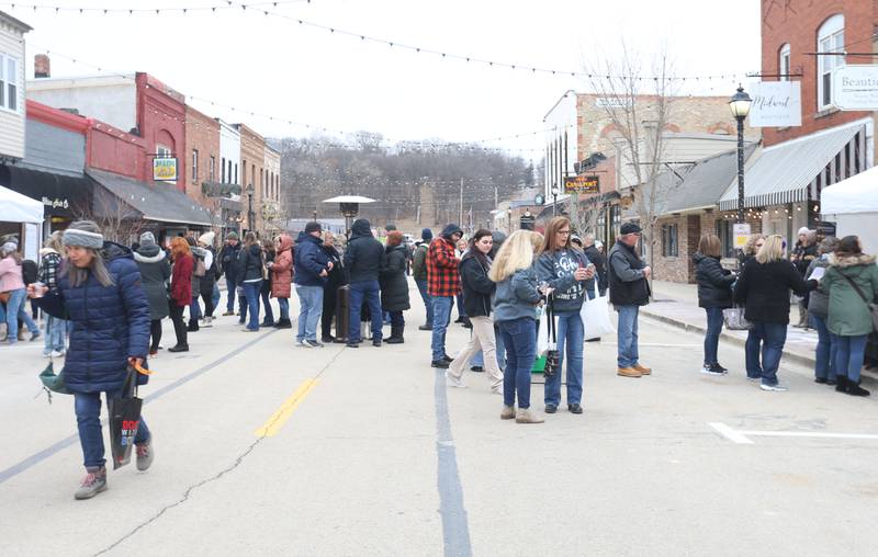 Dozens of wine enthusiasts stroll Mill Street during the Winter Wine Walk on Saturday, Feb. 8, 2025 at the Market on Mill plaza in Utica.