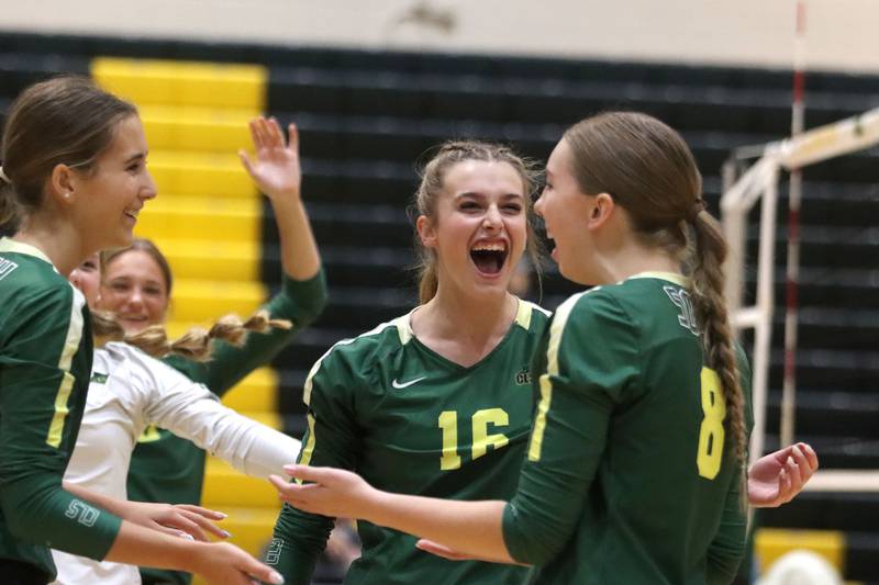 Crystal Lake South’s Sedona Semradek, center, celebrates with Anna Hougas, right, and the Gators against Crystal Lake Central in varsity volleyball at Crystal Lake South High School in Crystal Lake on Tuesday, Oct. 7, 2025.