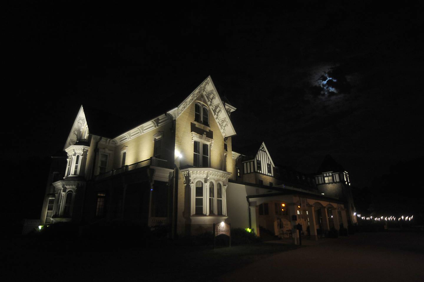 The Dole Mansion, 401 Country Club Road in Crystal Lake, in the moonlight before the start of one of Loren Purcell’s paranormal tours in the mansion. Purcell takes guests through the original building's three floors and offers historical anecdotes through the lens of spirit visitations while guests use pendulum crystals and dowsing rods as part of the tours for experiencing the visitations.