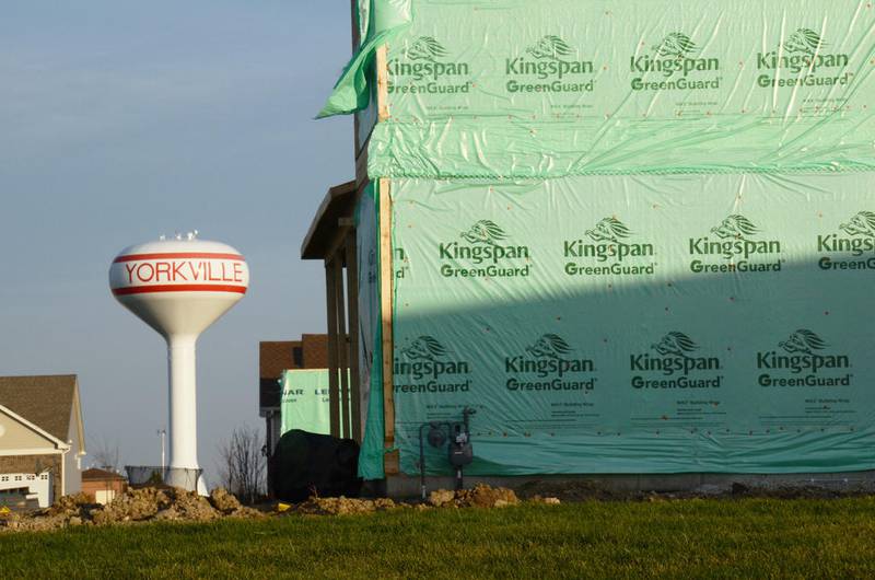 A Yorkville water tower looks over new homes under construction in the Raintree Village subdivision