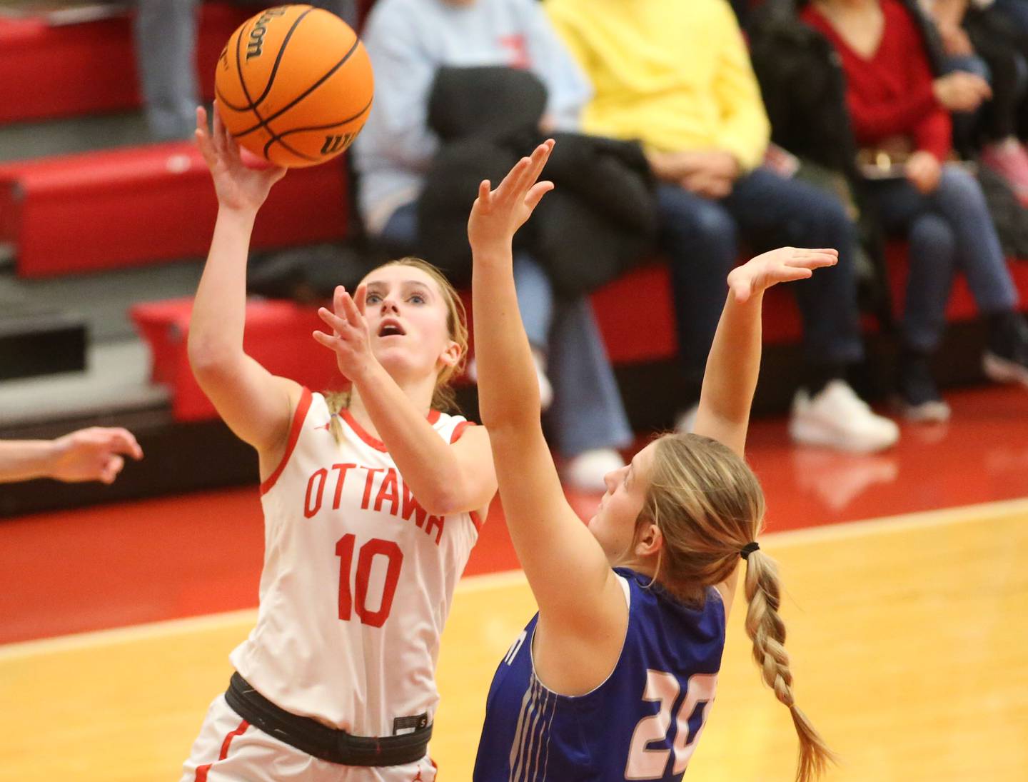 Ottawa's Ella Schmitz runs in for a layup as Princeton's Reese Revigilo defends on Monday, Feb. 3, 2025 in Kingman Gymnasium at Ottawa High School.